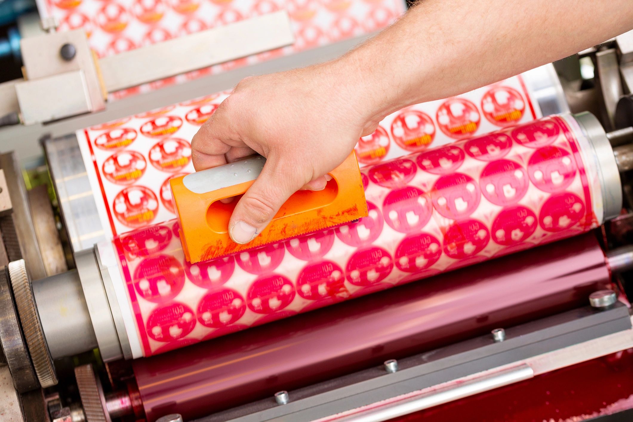 Close-up of a flexographic printing press station during production.